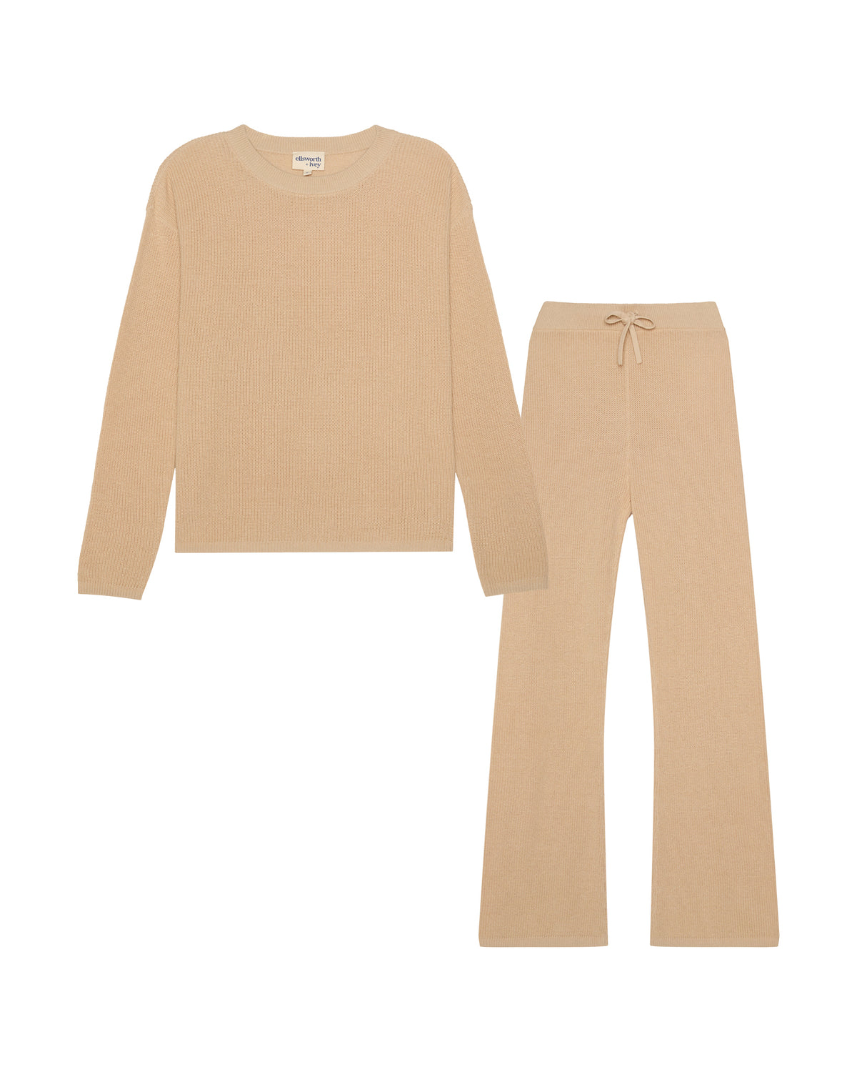 A two-piece knit loungewear set in a light tan sand color, featuring a long-sleeve crewneck top and matching wide-leg pants with a drawstring waist, displayed on a solid white background. Adeline Knit Set in Sand by Ellsworth + Ivey.