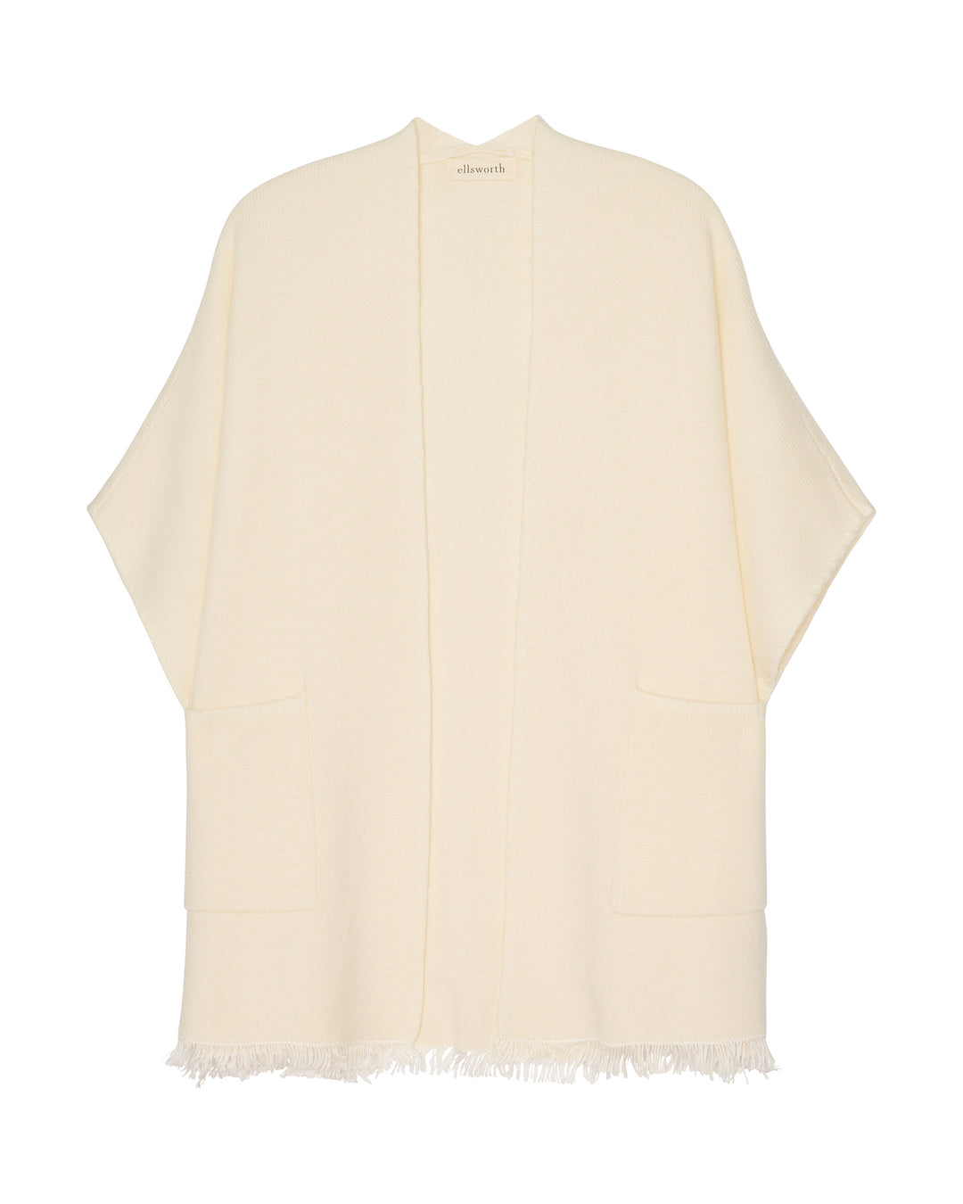 An ivory cream open-front cashmere women's cape cardigan with wide sleeves and fringed edges, shown flat against a white background. Amelia Cape in Ivory by Ellsworth + Ivey.