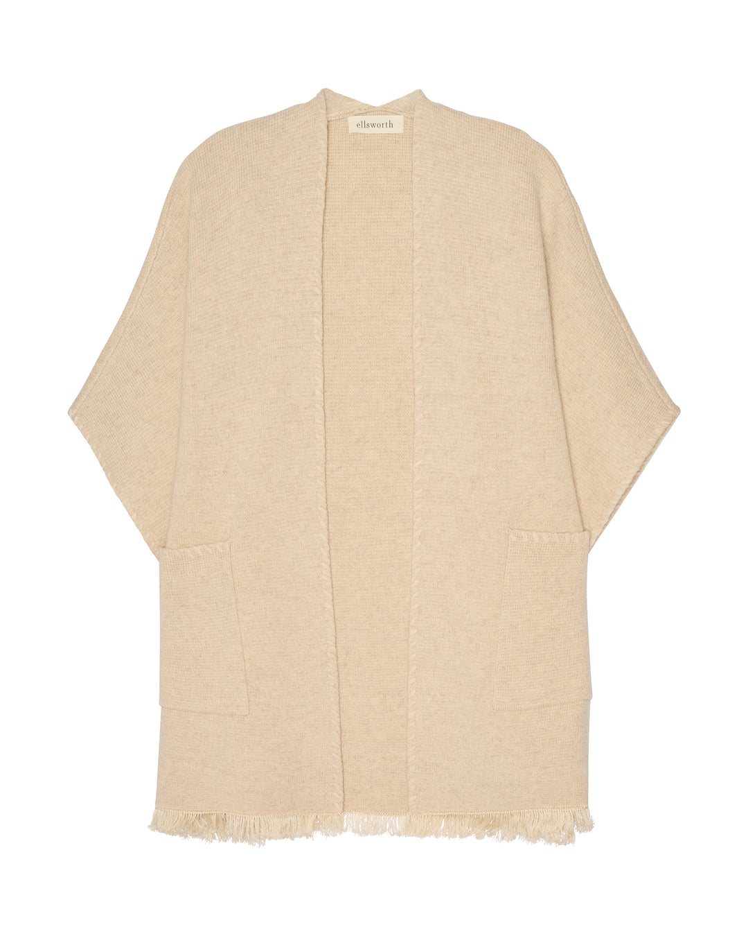 A light oatmeal beige open-front cashmere women's cardigan with wide sleeves and fringed edges, shown flat against a white background. Amelia Cape in Oatmeal by Ellsworth + Ivey.