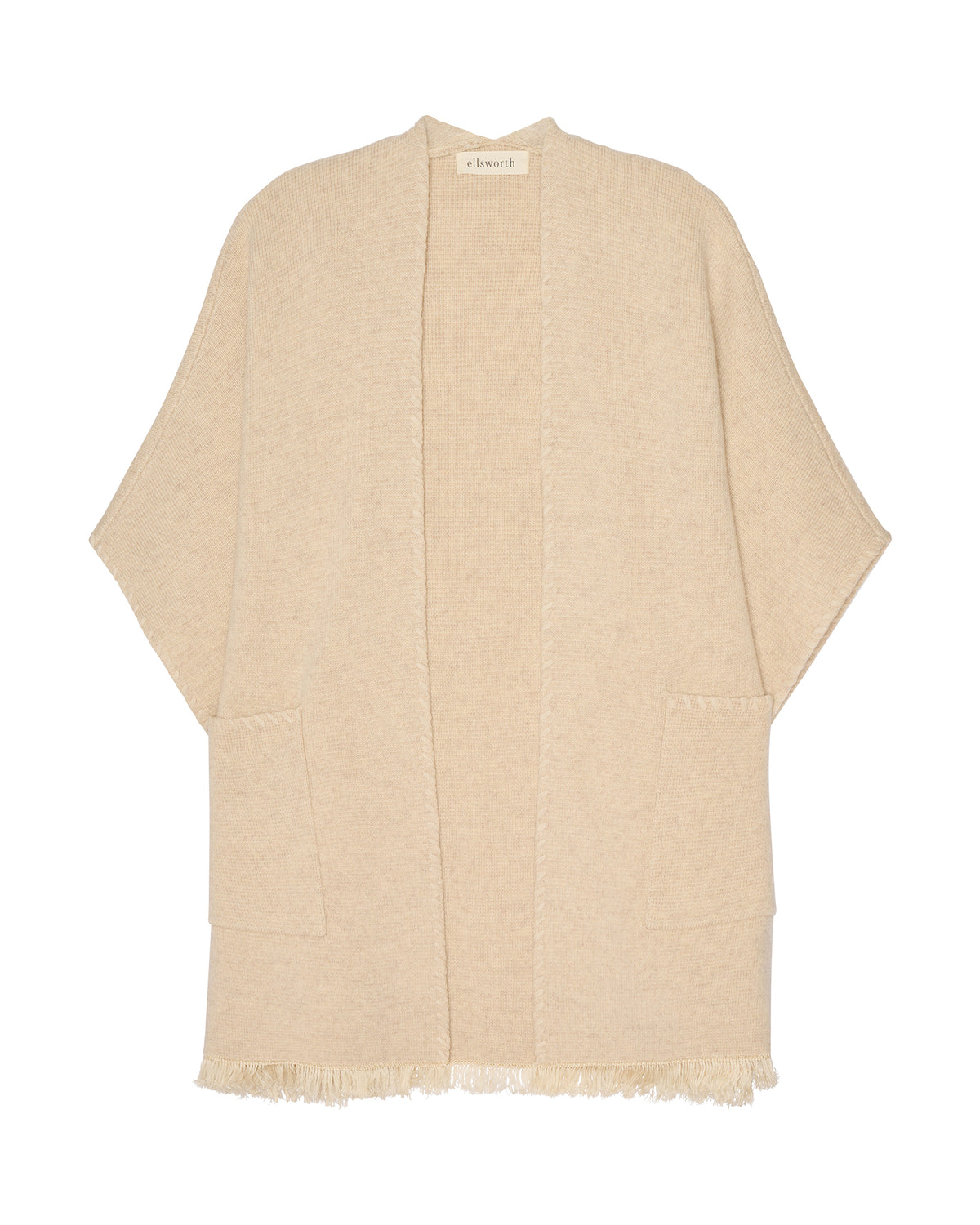 A light oatmeal beige open-front cashmere women's cardigan with wide sleeves and fringed edges, shown flat against a white background. Amelia Cape in Oatmeal by Ellsworth + Ivey.