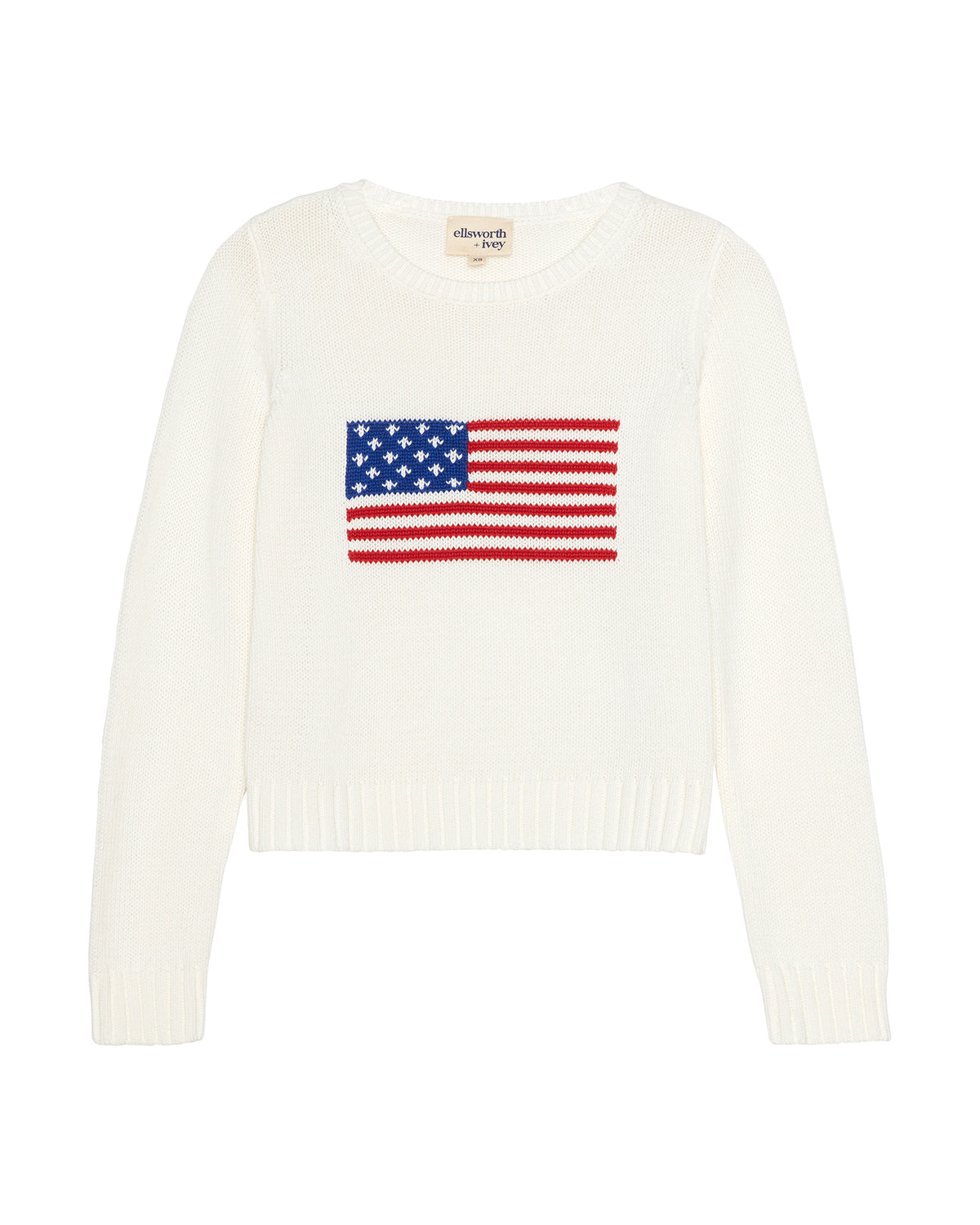 An ivory off-white knit women's crewneck sweater featuring a knitted American flag graphic on the chest, displayed against a solid white background. Autumn Crew Sweater - American Flag by Ellsworth + Ivey.