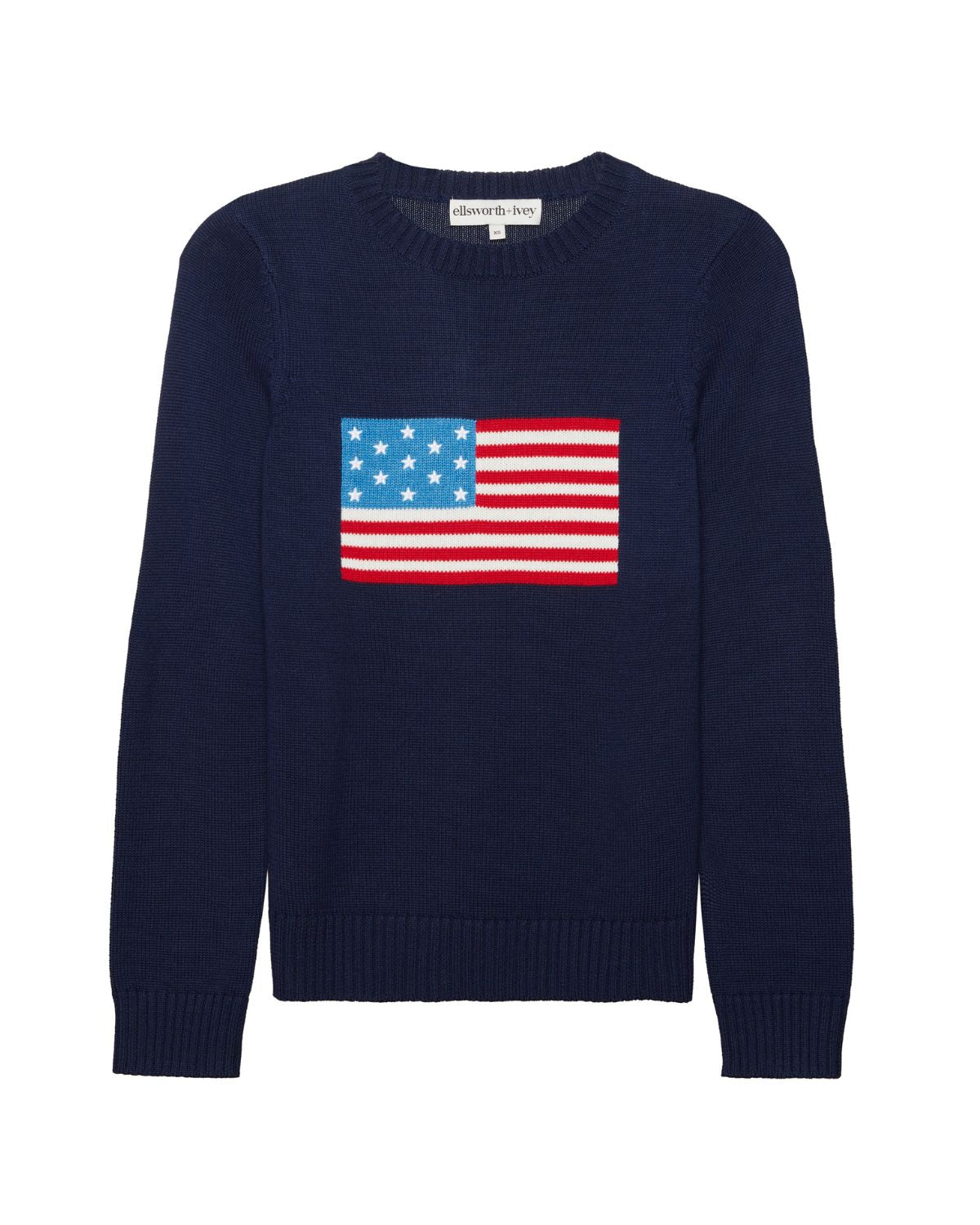 A navy blue women's crewneck sweater featuring an embroidered graphic of the American flag on the chest, displayed against a solid white background. Classic Crew Sweater - American Flag by Ellsworth + Ivey.