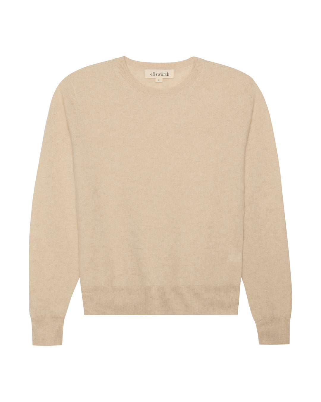 A light oatmeal beige crewneck knit cashmere women's sweater with long sleeves and ribbed cuffs and hem, shown flat against a white background. Daphne Crew in Oatmeal by Ellsworth + Ivey.
