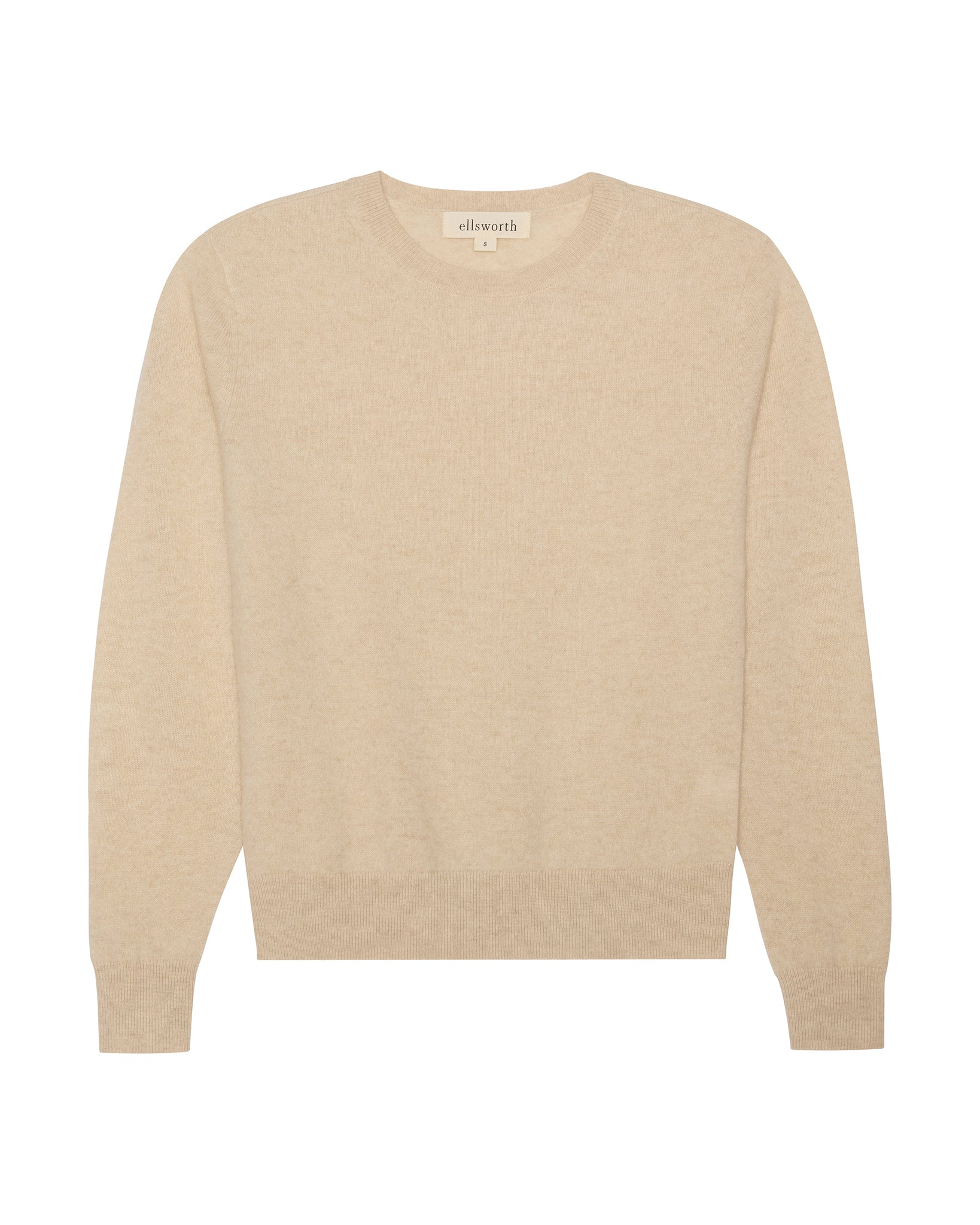 A light oatmeal beige crewneck knit cashmere women's sweater with long sleeves and ribbed cuffs and hem, shown flat against a white background. Daphne Crew in Oatmeal by Ellsworth + Ivey.