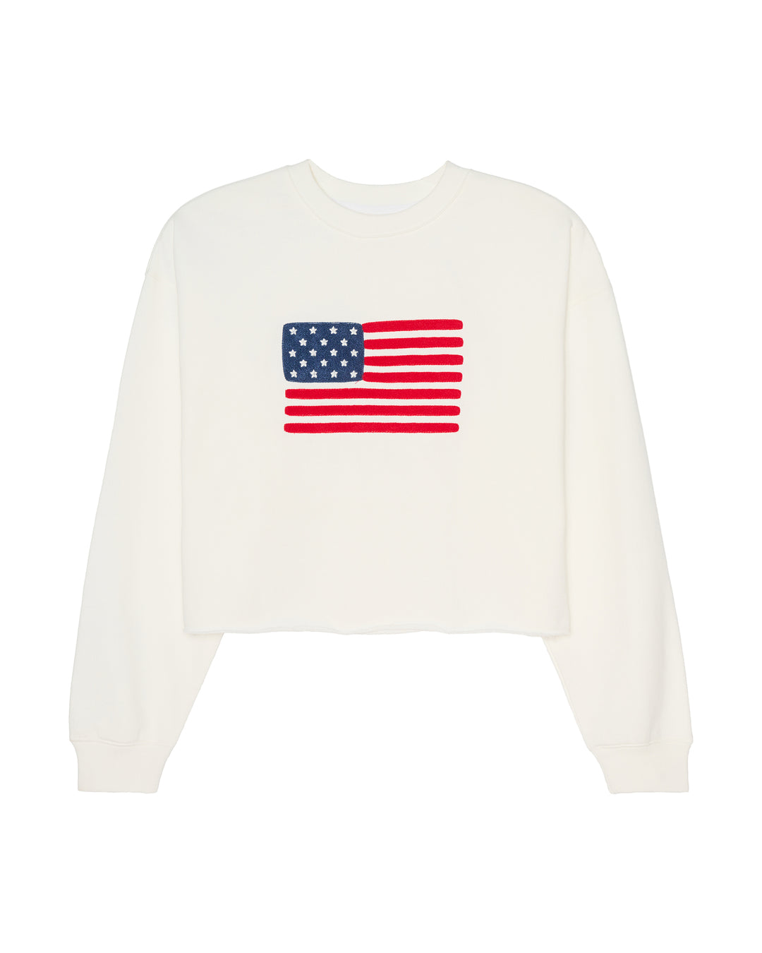 An ivory off-white cropped women's crewneck sweatshirt featuring a graphic of the American flag on the chest, displayed against a solid white background. Ellie American Flag Sweatshirt by Ellsworth + Ivey.
