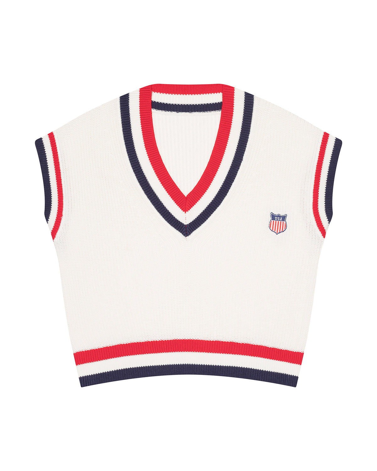 A cream-colored ribbed knit women's Americana sweater vest with navy and red striped trim on the V-neck, sleeve cuffs, and hem, featuring a small US flag embroidered shield logo on the left chest. McKenna Sweater Vest - American Shield by Ellsworth+ Ivey.