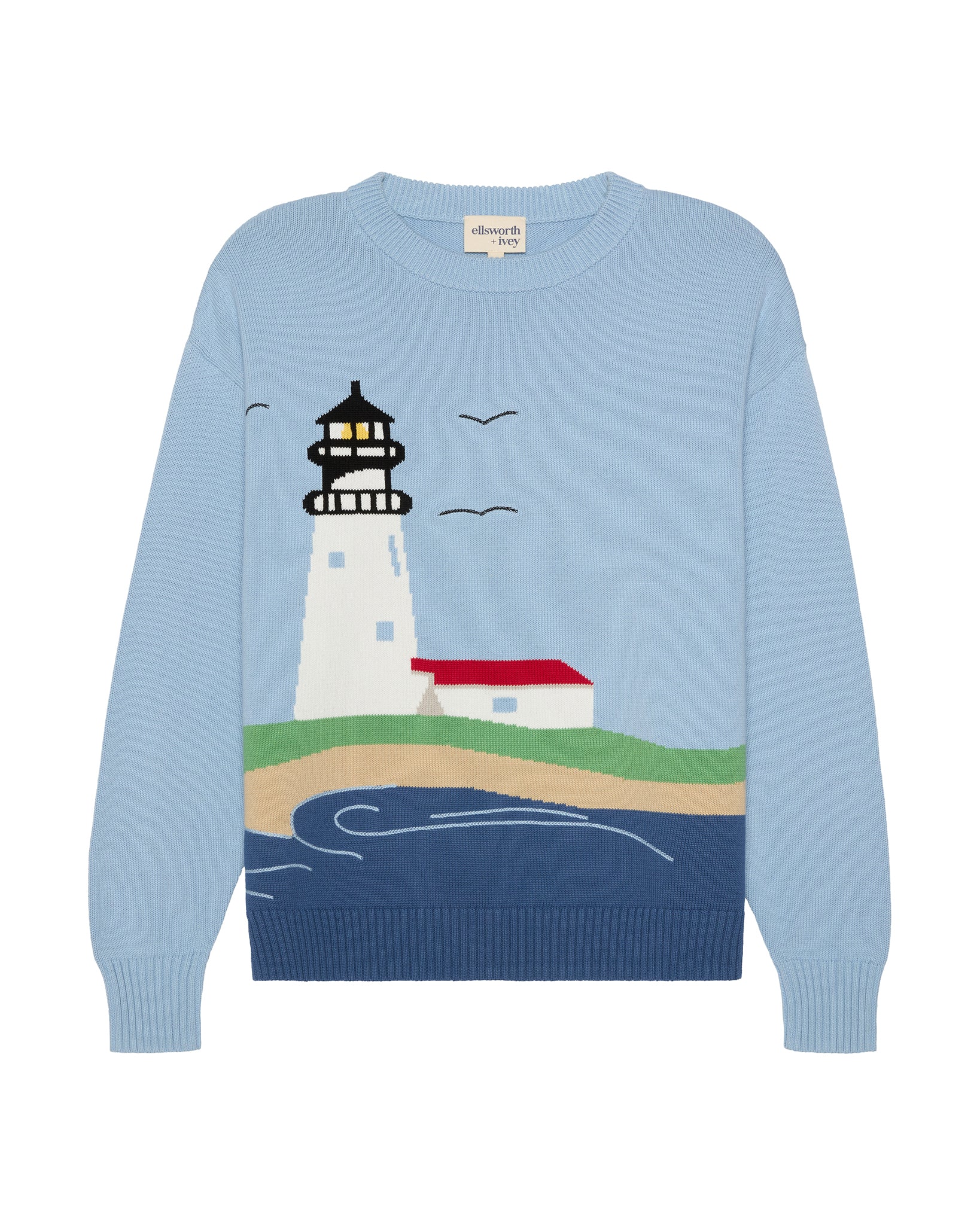 A light blue crewneck women's sweater featuring a knitted graphic of a Nantucket lighthouse, a small red-roofed building, birds, and stylized waves on a blue background. Riley ACK Lighthouse Scenery Sweater by Ellsworth + Ivey.