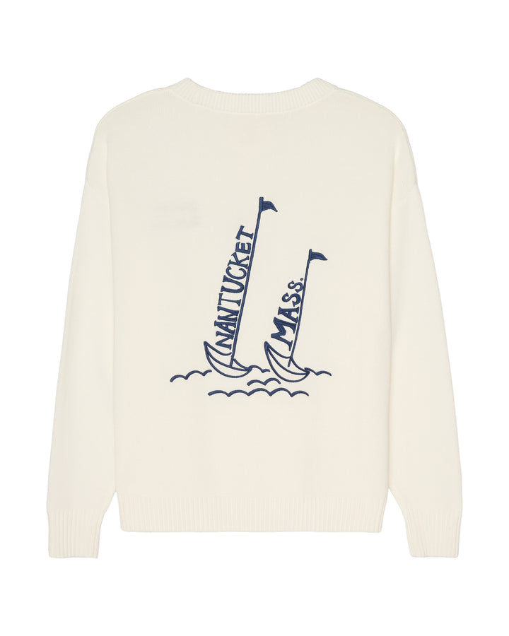 An ivory crewneck sweater featuring a navy blue graphic of two sailboats on the front, with &