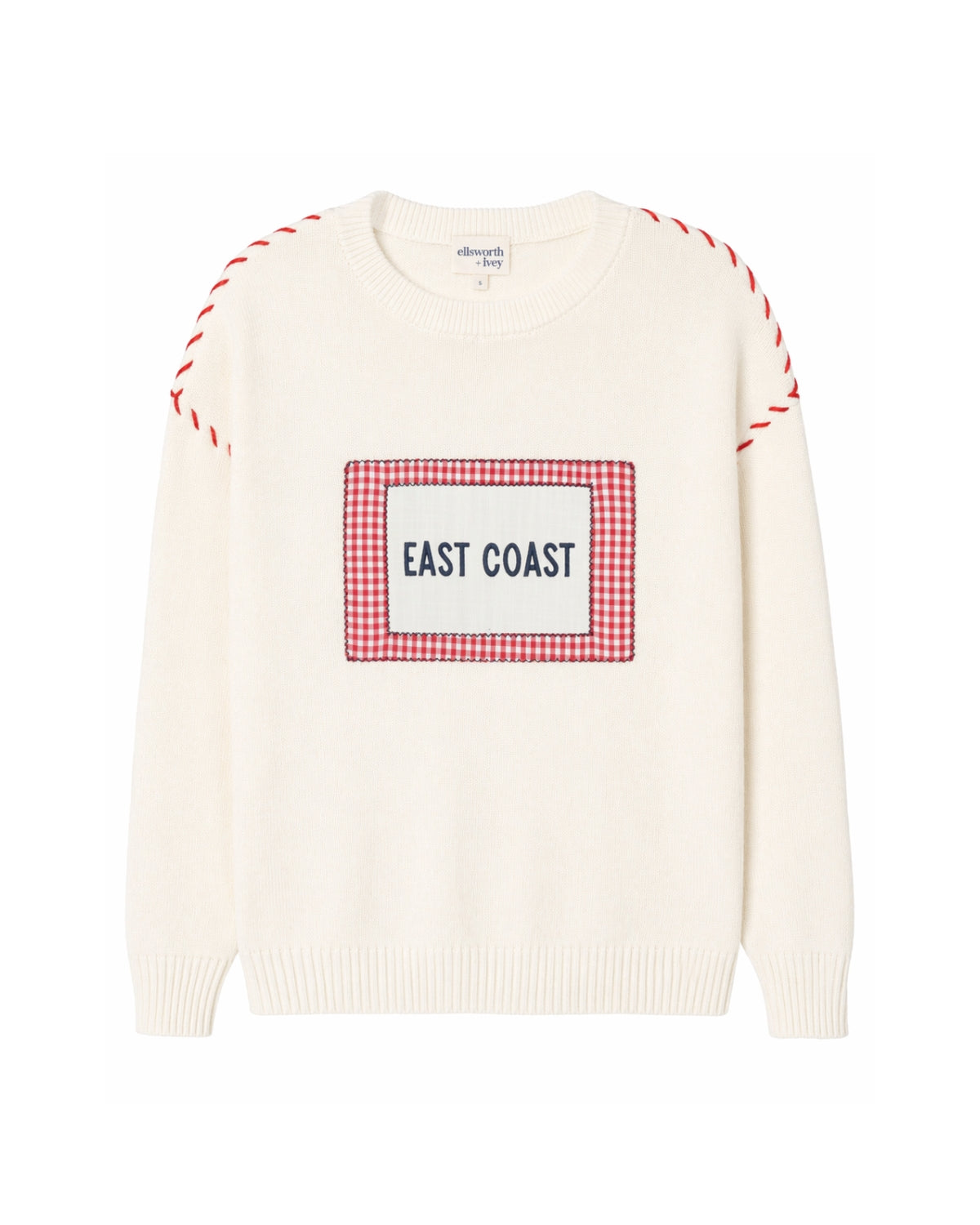 An off-white knit sweater with a red and white gingham graphic on the chest that reads 'EAST COAST' in navy text. The sleeves feature red and white whip stitch details near the shoulders, all shown against a plain white background.  Ellsworth + Ivey Riley Crew - East Coast.
