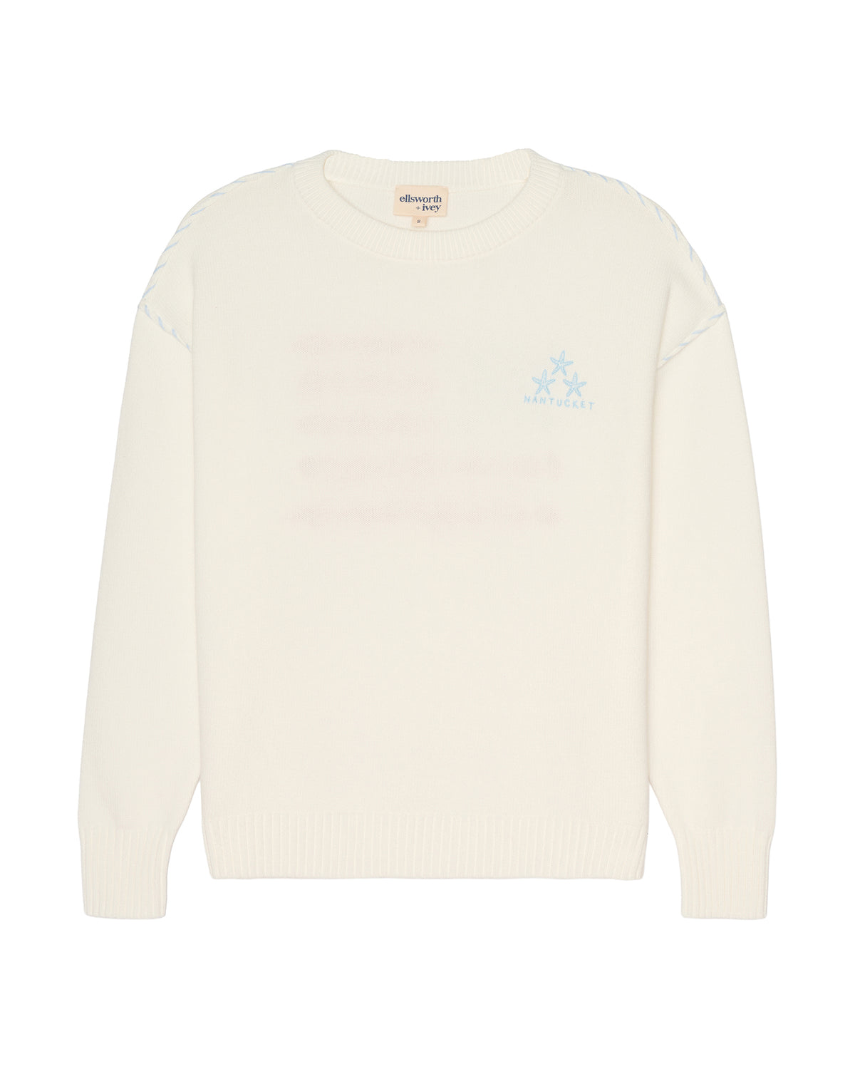An off-white knit crewneck sweater with a light blue embroidered logo on the left chest, displayed against a solid white background. Ellsworth + Ivey Riley Stars and Shells Flag Sweater.