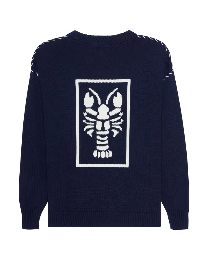 A navy blue knit sweater with a large white lobster graphic inside a rectangular border on the back, featuring white contrast stitching along the shoulders. Riley Crew Sweater - ACK Nantucket Lobster by Ellsworth + Ivey.