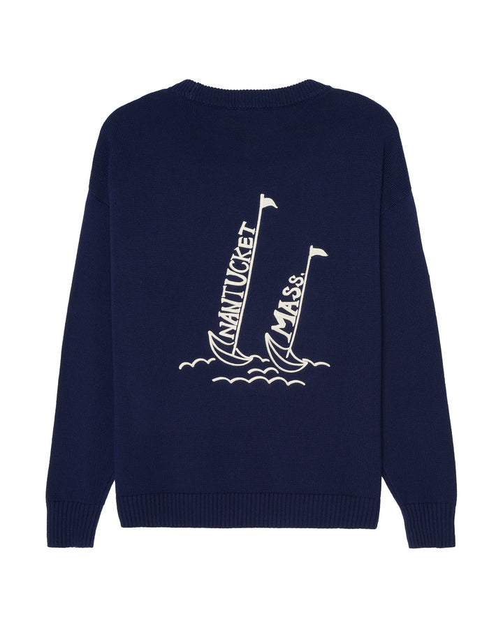 A navy blue crewneck sweater shown from the back, featuring a white graphic of two sailboats with &