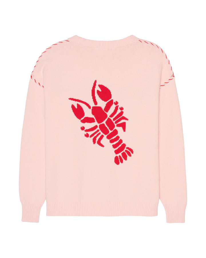A light pink knit sweater with a large red lobster graphic on the back, featuring red dashed stitching along the shoulders, shown against a plain white background. Riley Crew Sweater - ACK Lobster - Ellsworth + Ivey.